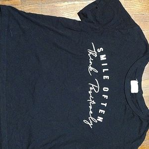 Black tees that say"smile often think positive"with sunflowers on the back